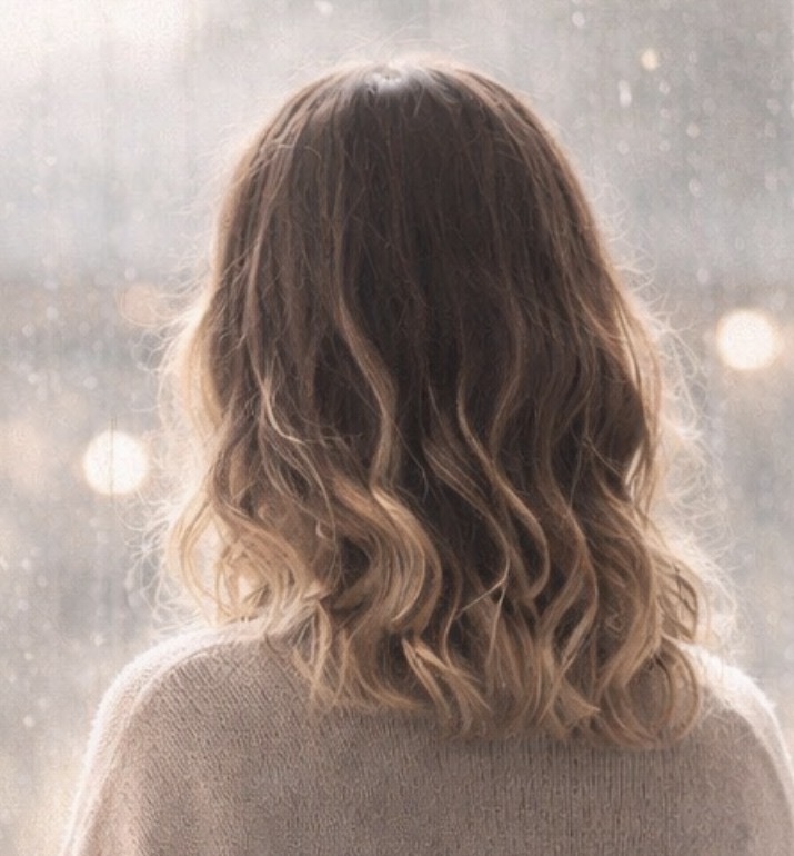 Back of woman’s head looking out window